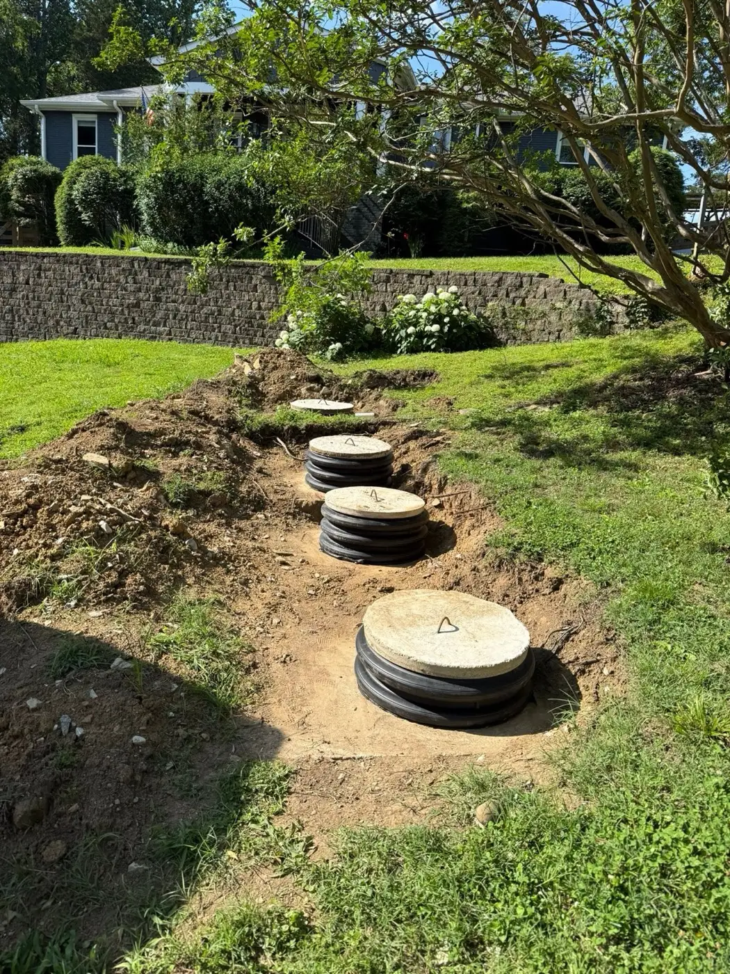 Row of septic tank risers exposed during a system check